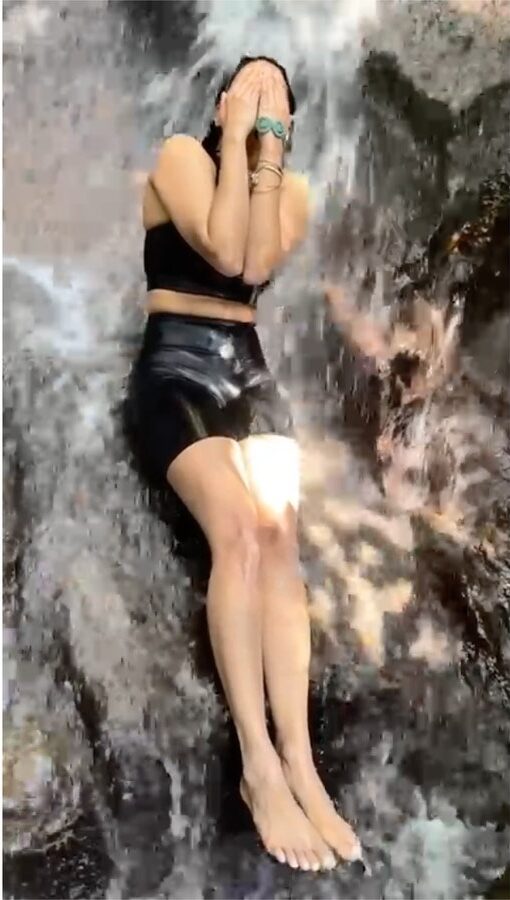 Aishwarya Lekshmi swimming in a waterfall in Bali