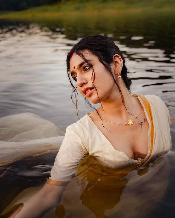 Priya Varrier sexy saree photoshoot in a pond